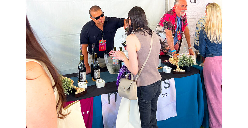 Mike pouring from behind a table set up with our wines.