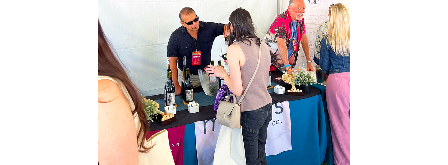 Mike pouring from behind a table set up with our wines.